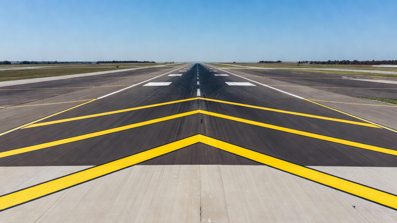 Aerial view of airport runway end with stopway marked by yellow chevron markings