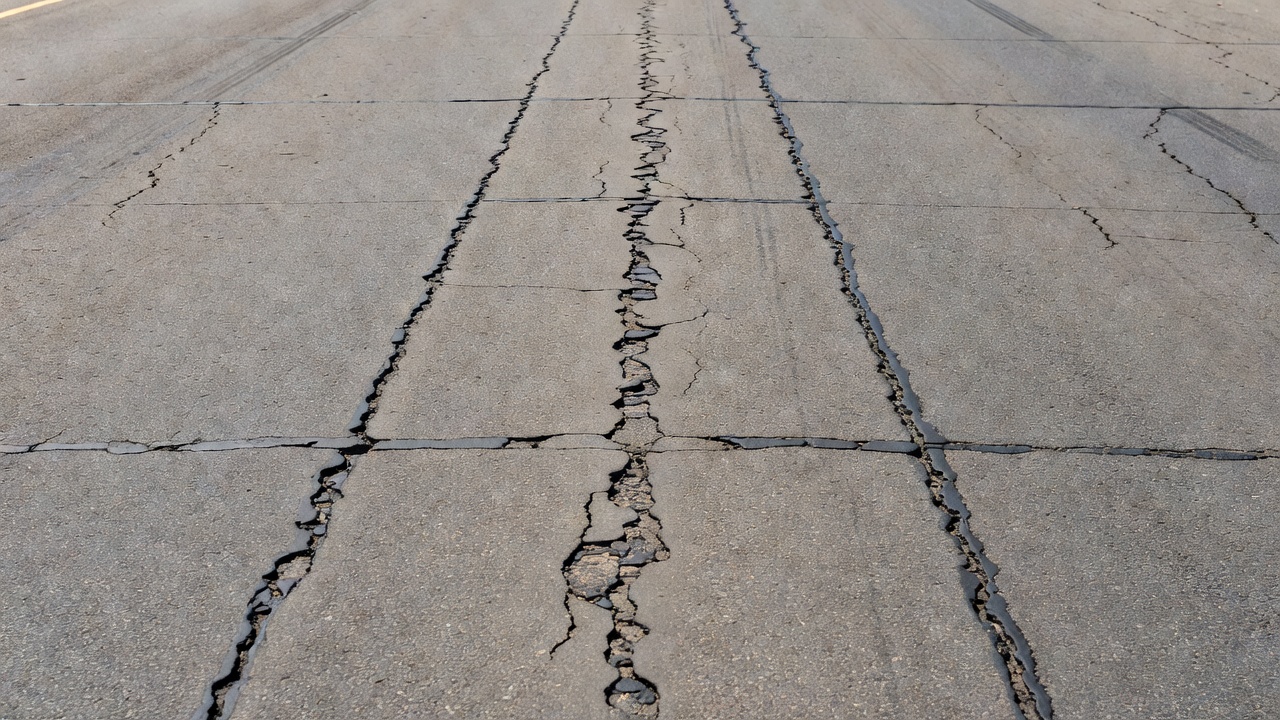Asphalt pavement thermal cracking distress showing transverse cracks across a road surface with pavement condition assessment documentation