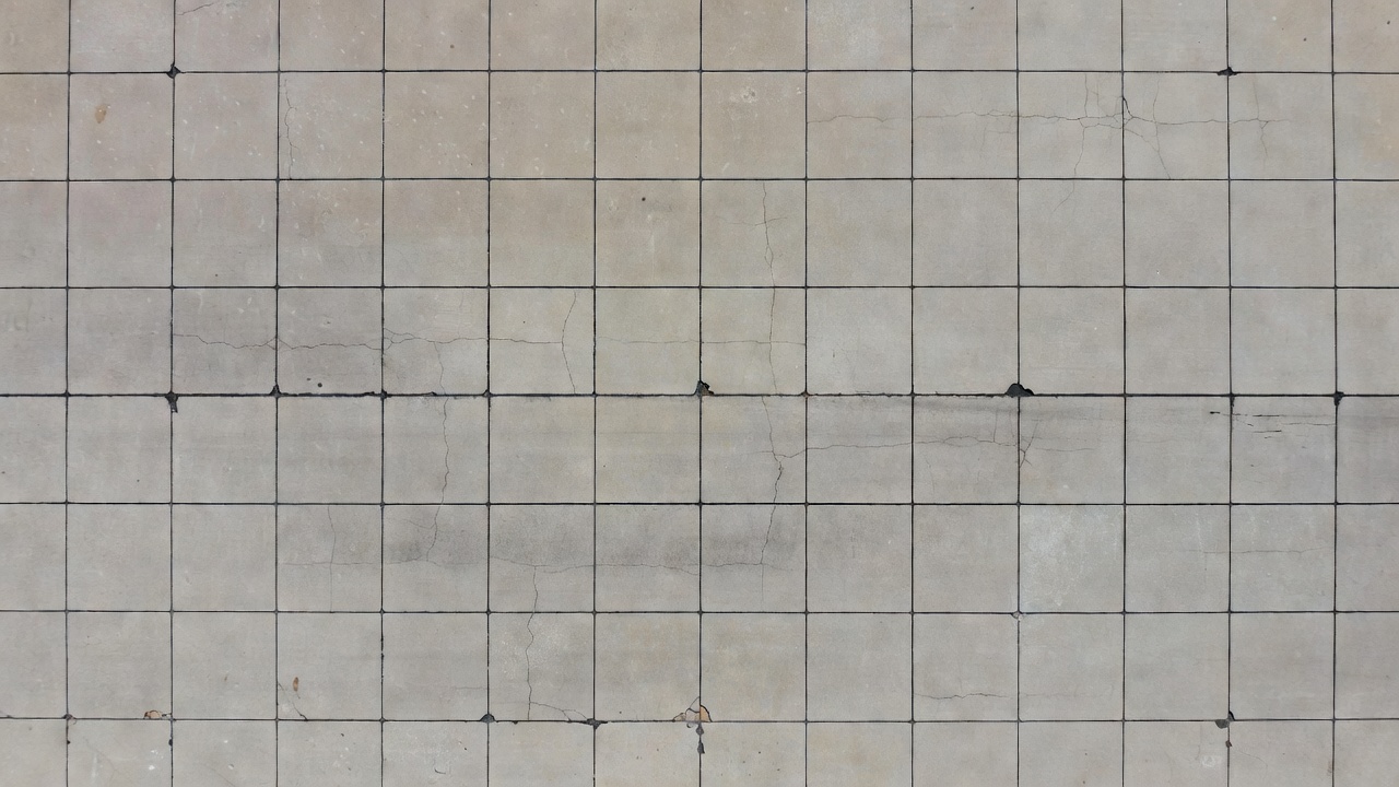 Drone aerial view of concrete airport runway pavement with visible transverse joints for curling and condition assessment