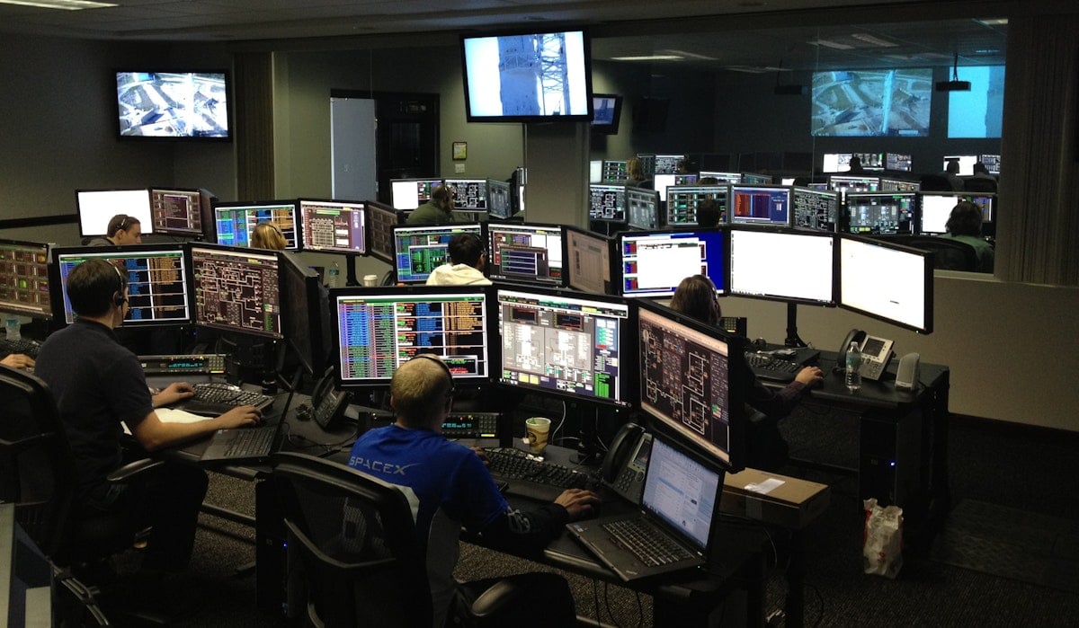 Airport Operations Center with co-located stakeholders at shared consoles.